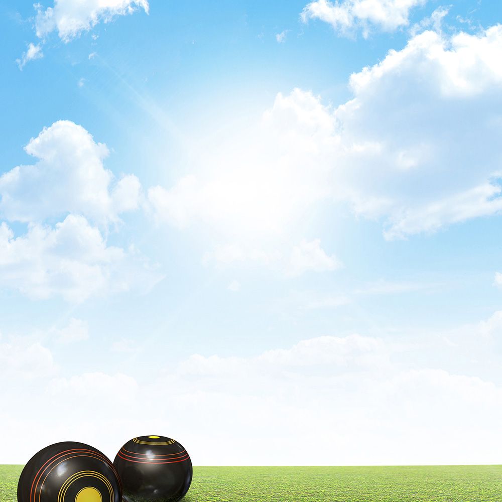 Lawn bowls on green grass with blue skies