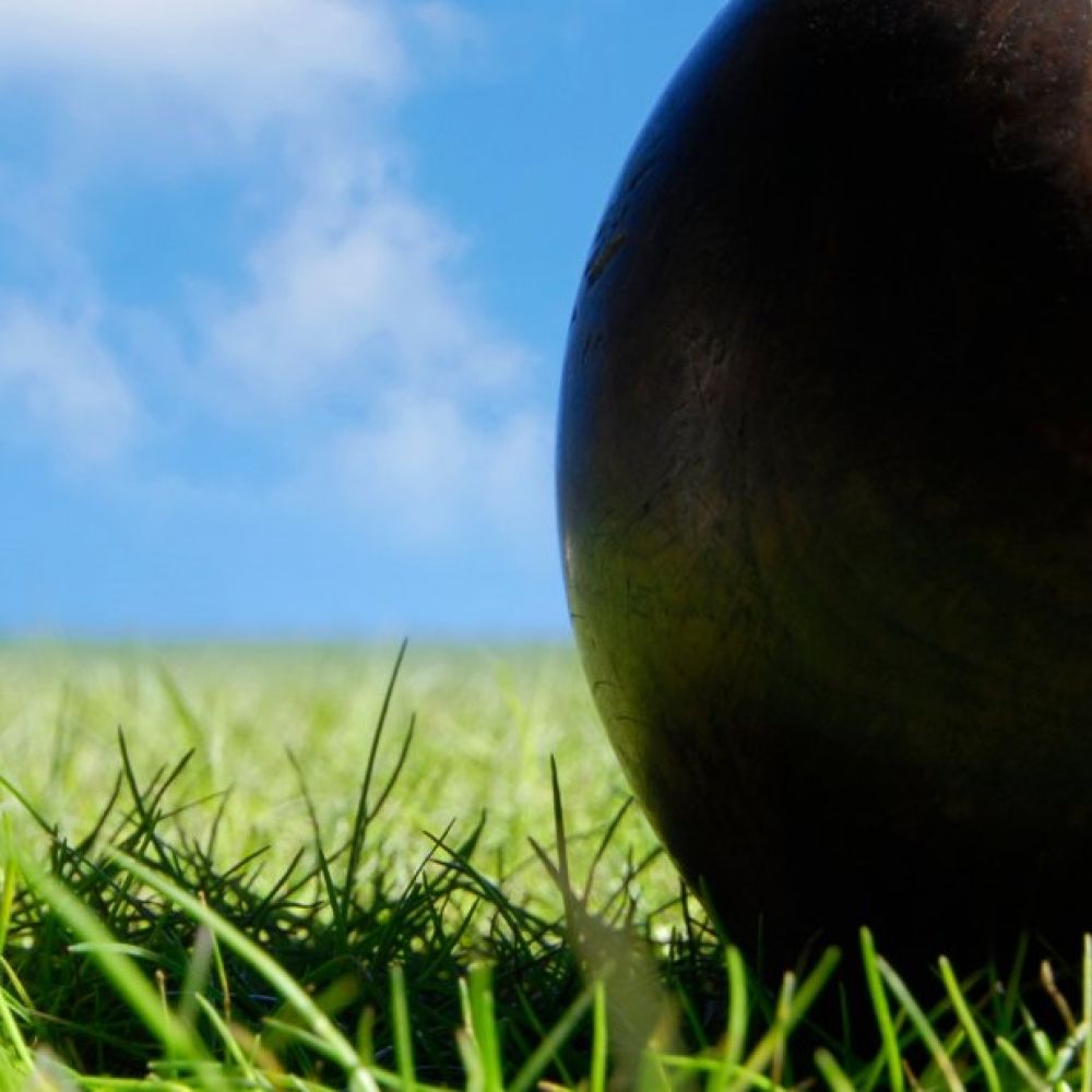 Lawn bowls on green grass with blue skies
