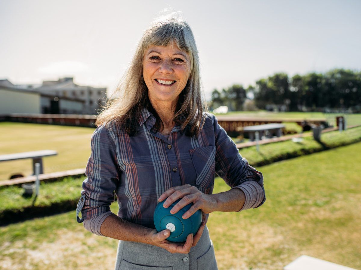 Lawn bowling member holding lawn bowl