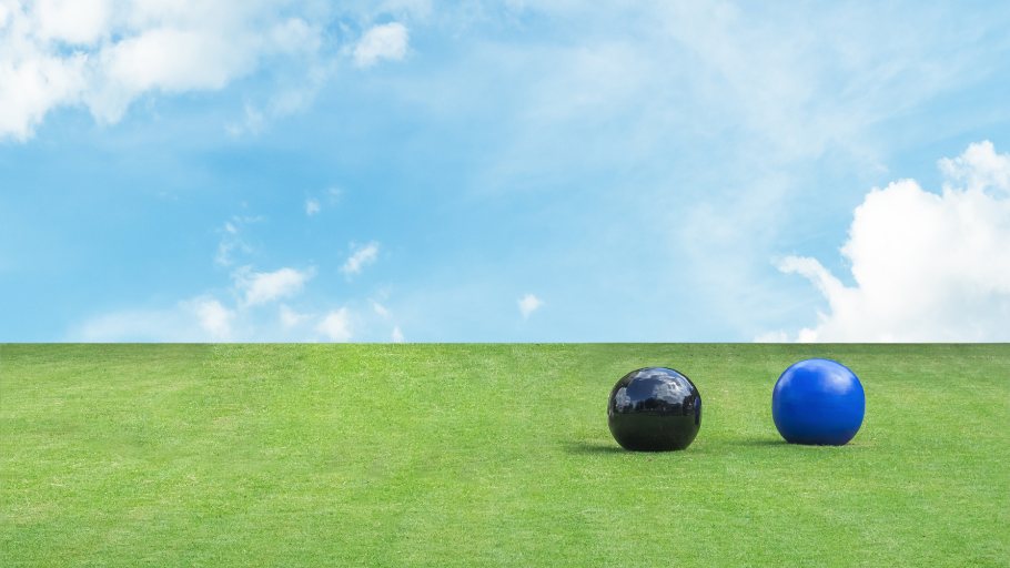 Lawn bowls on grass with blue skies
