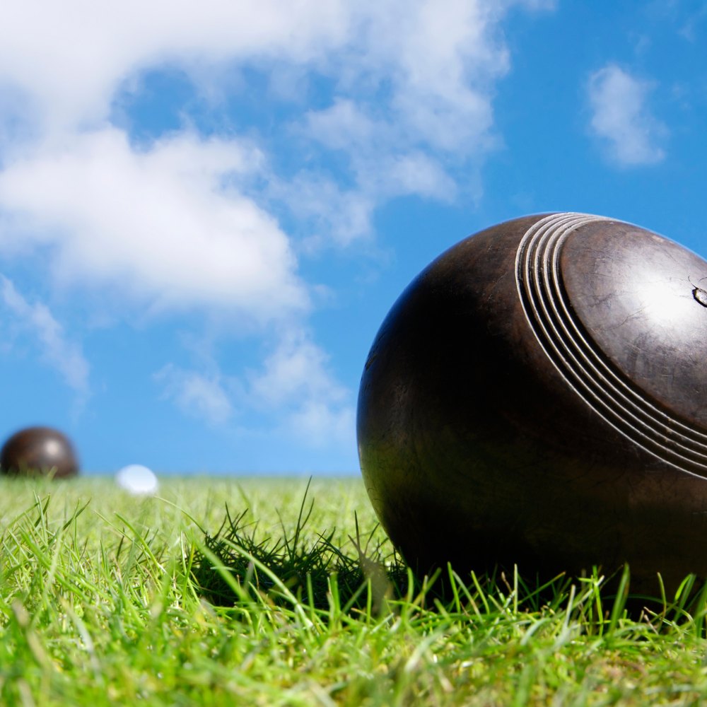 Lawn bowls on green grass and blue skies