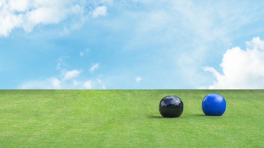Lawn bowls on grass with blue skies