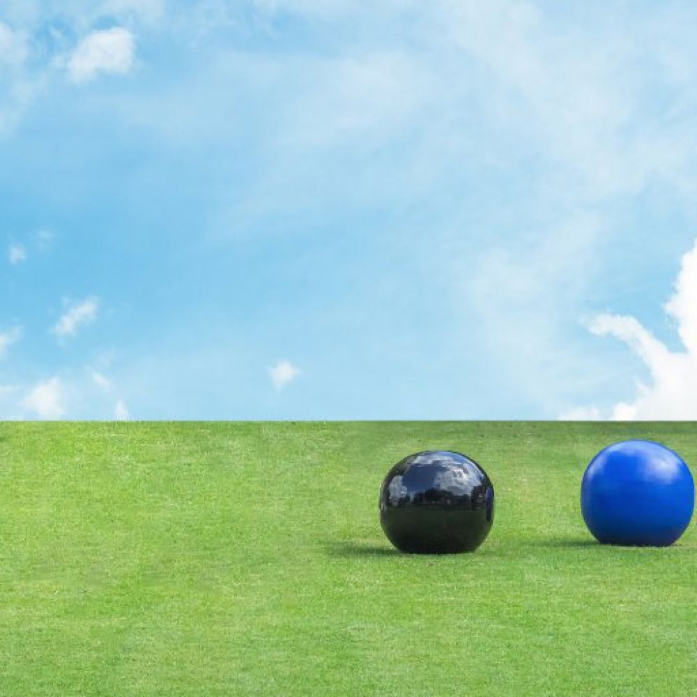 Lawn bowls on green grass and blue skies